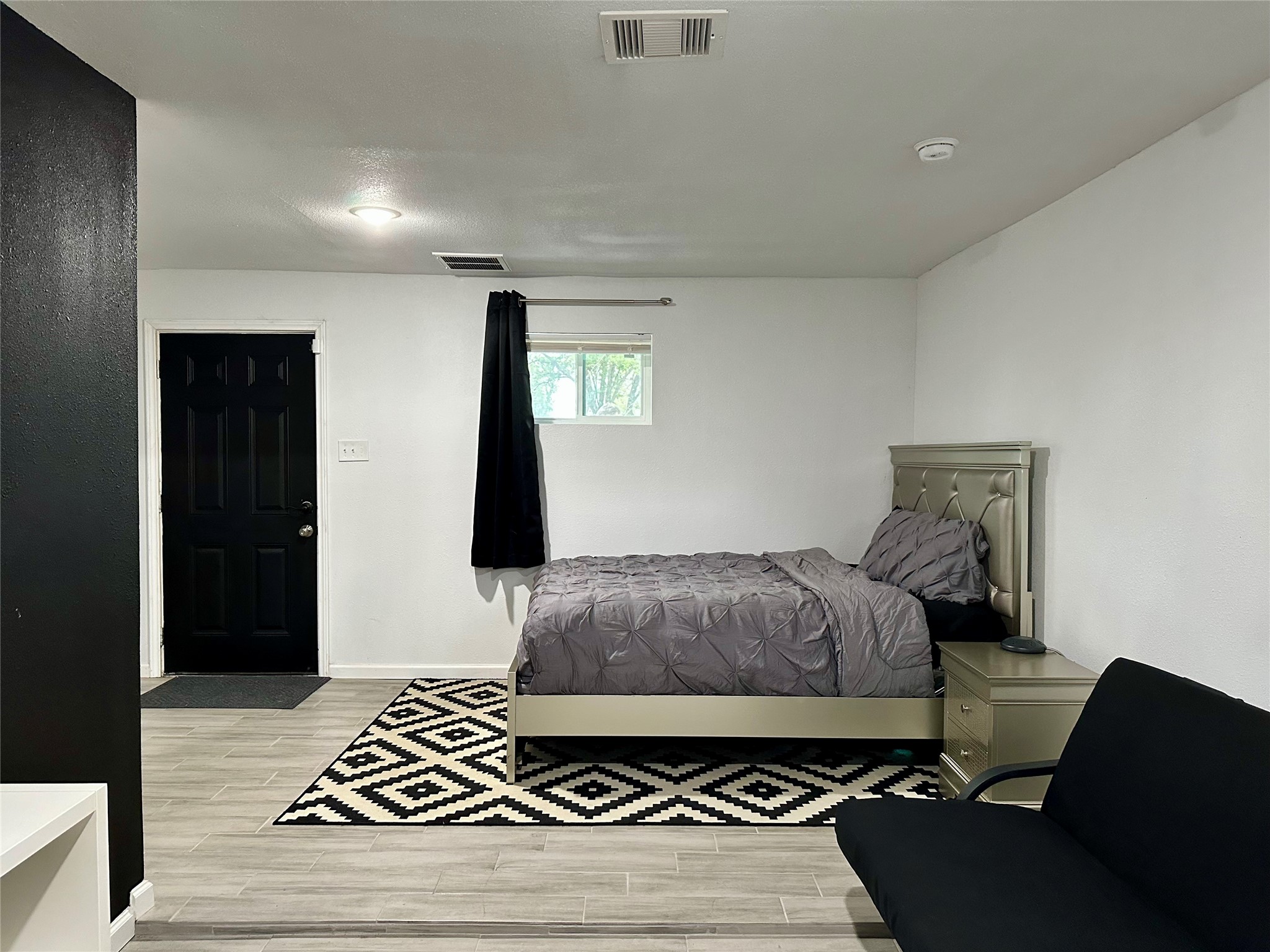 4802 Elser Street Houston, TX 77009 - Photo 10 of 21 a bedroom with a bed and a rug