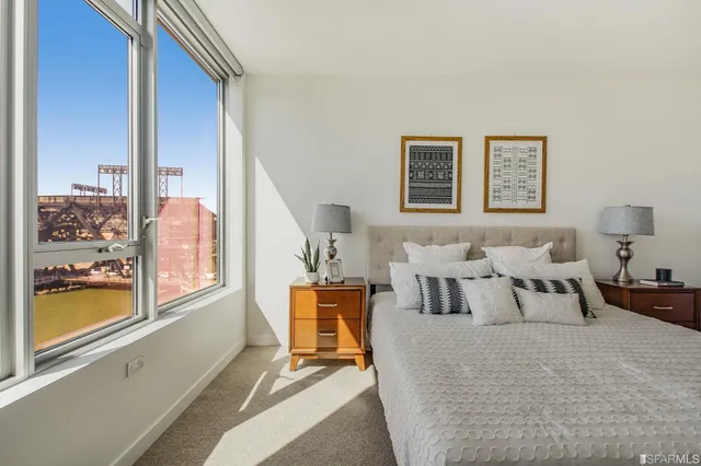a bedroom with furniture and a large window