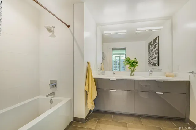 a bathroom with a tub sink and mirror