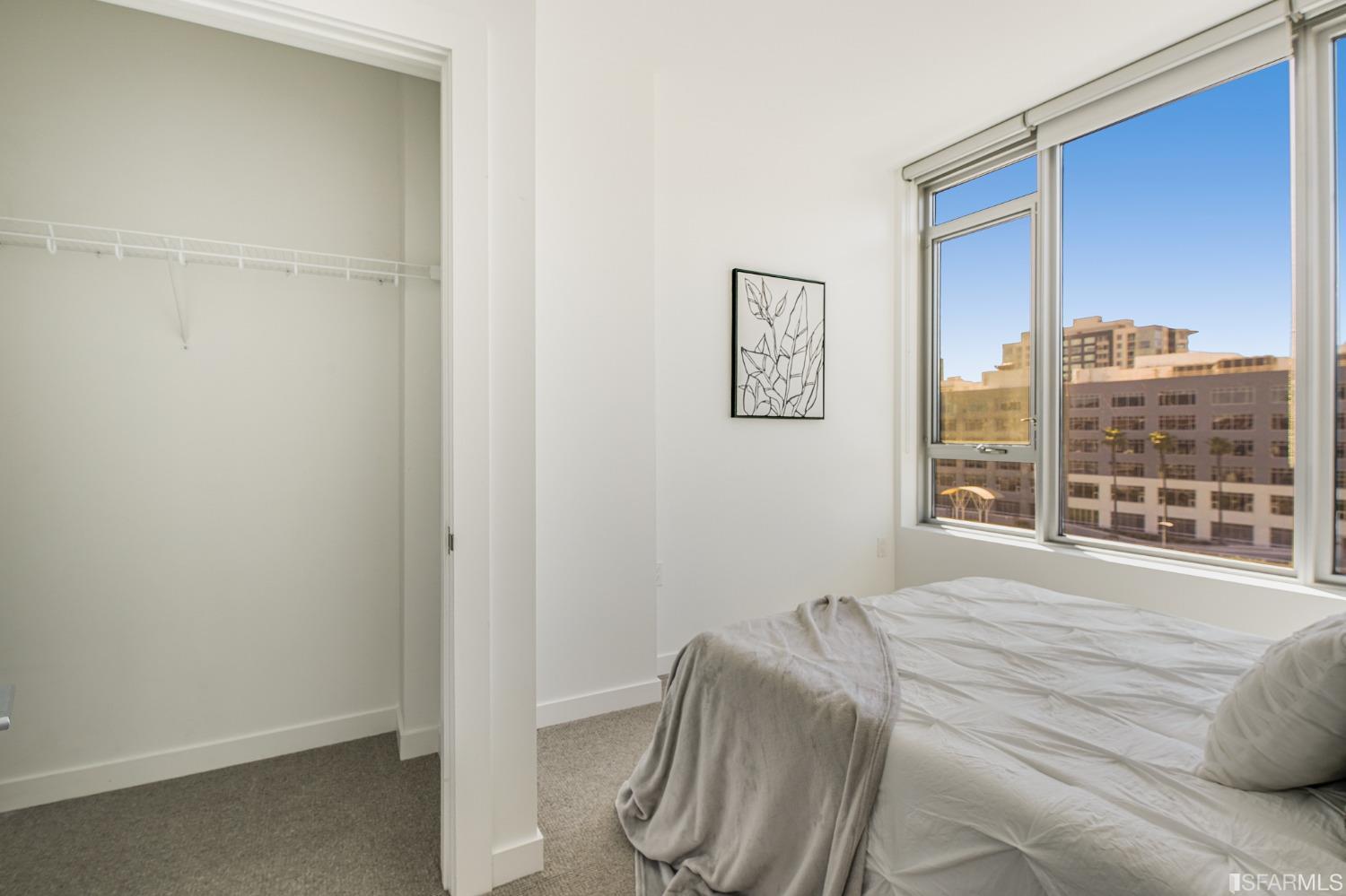 1000 3rd Street, Unit 605 San Francisco, CA 94158 - Photo 17 of 36 a bedroom with a bed and wooden floor