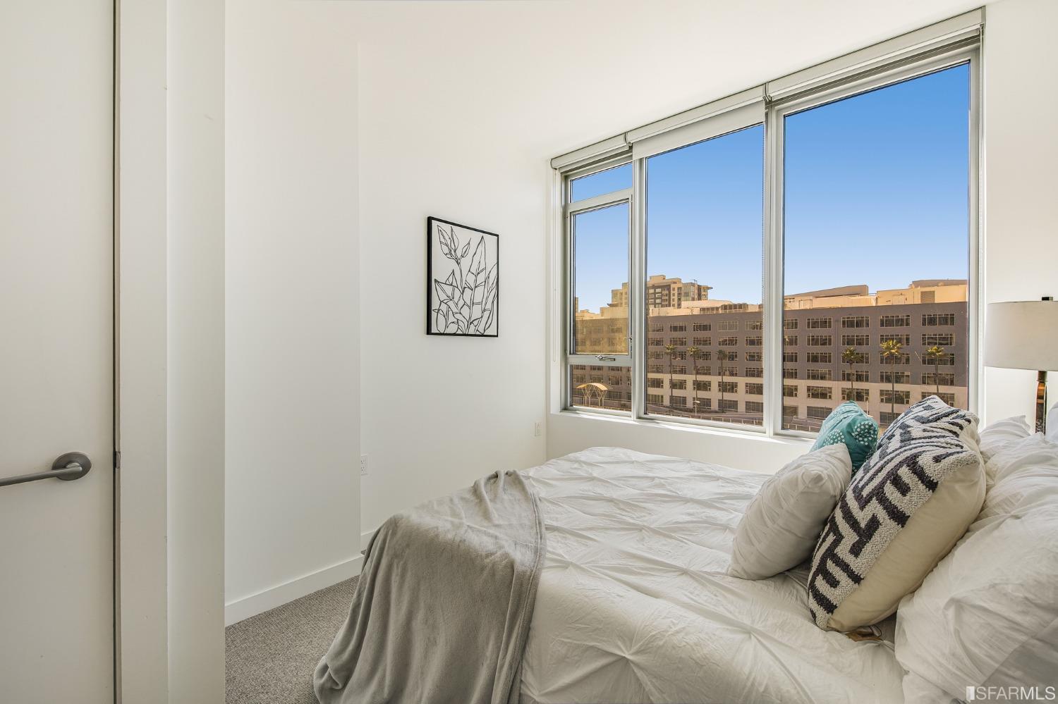 1000 3rd Street, Unit 605 San Francisco, CA 94158 - Photo 18 of 36 a bed sitting in a bedroom next to a window