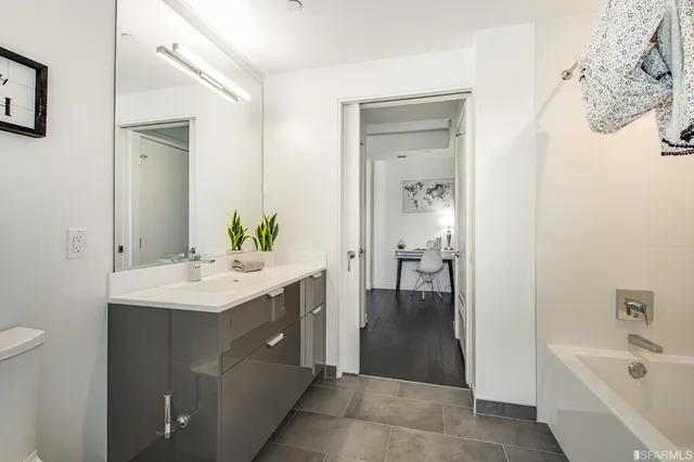 a bathroom with a sink a mirror and a bathtub