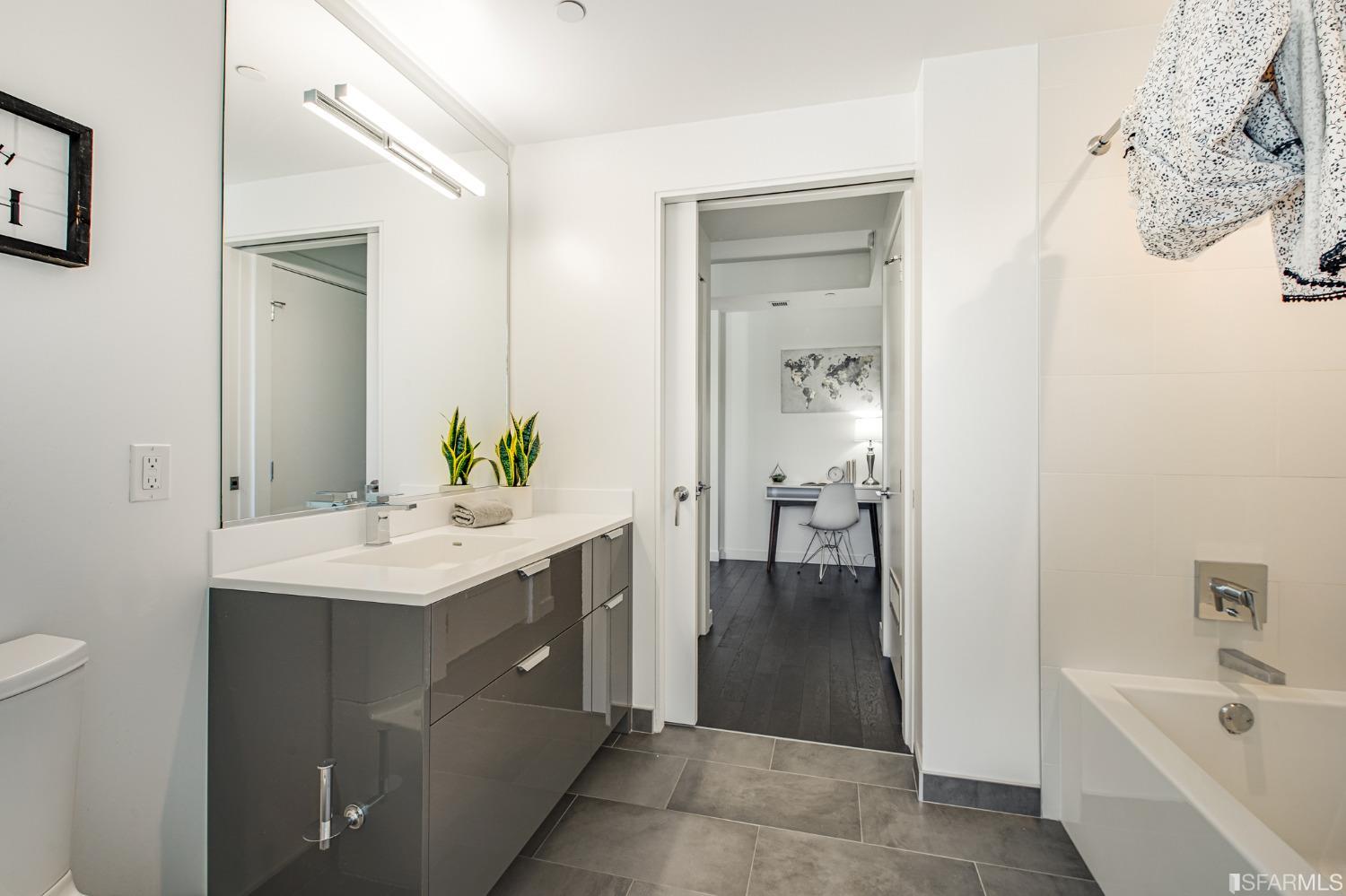 1000 3rd Street, Unit 605 San Francisco, CA 94158 - Photo 20 of 36 a bathroom with a sink a mirror and a bathtub