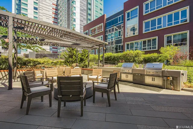 a view of a patio with a table and chairs and potted plants