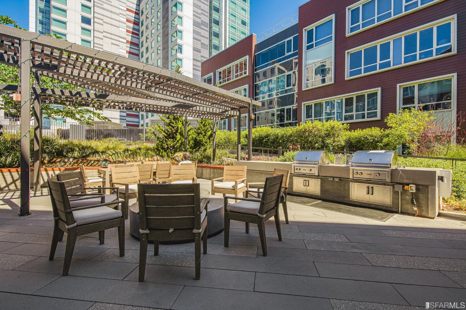 1000 3rd Street, Unit 605 San Francisco, CA 94158 - Photo 29 of 36 a view of a patio with a table and chairs and potted plants