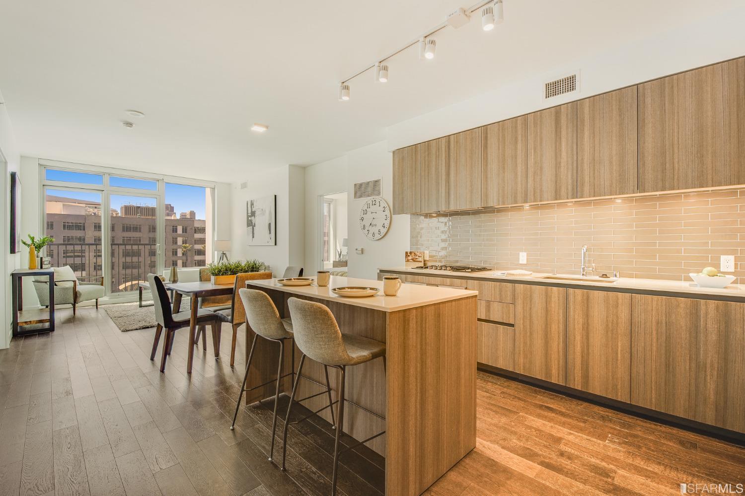 1000 3rd Street, Unit 605 San Francisco, CA 94158 - Photo 8 of 36 a kitchen with a table chairs sink and cabinets