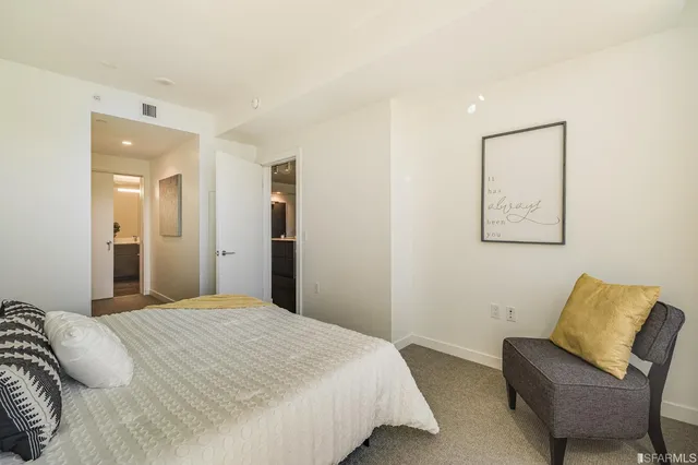 a bedroom with a bed and a couch