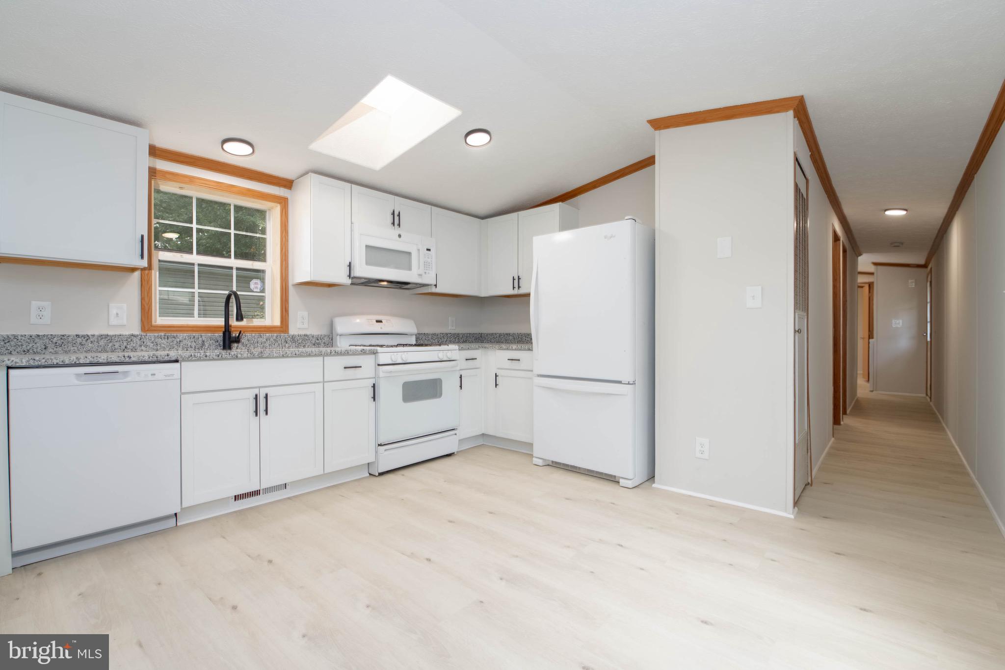 11540 Philadelphia Road White Marsh, MD 21162 - Photo 11 of 32 a kitchen with white cabinets and white appliances