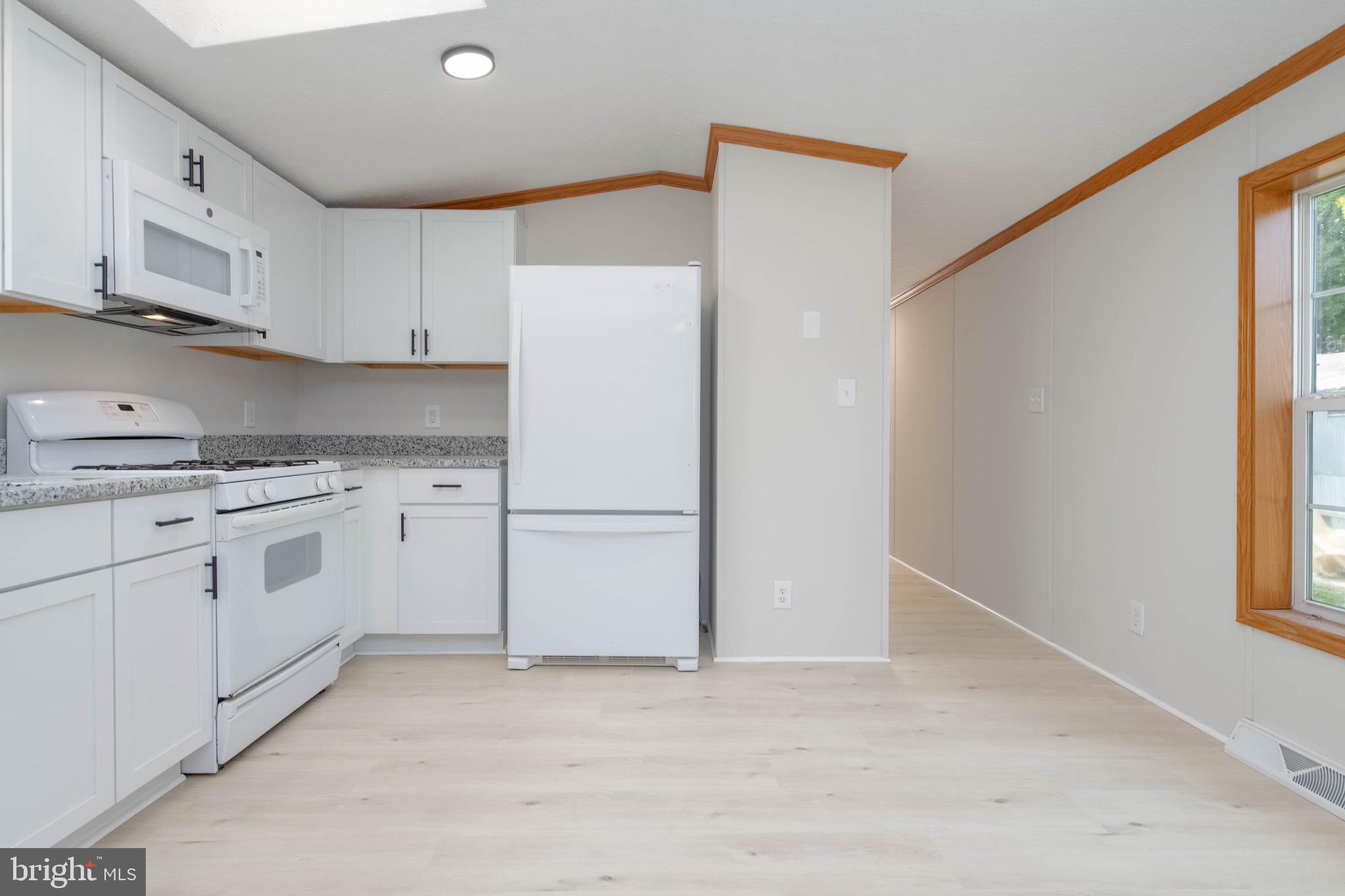 11540 Philadelphia Road White Marsh, MD 21162 - Photo 12 of 32 a kitchen with white cabinets and white appliances