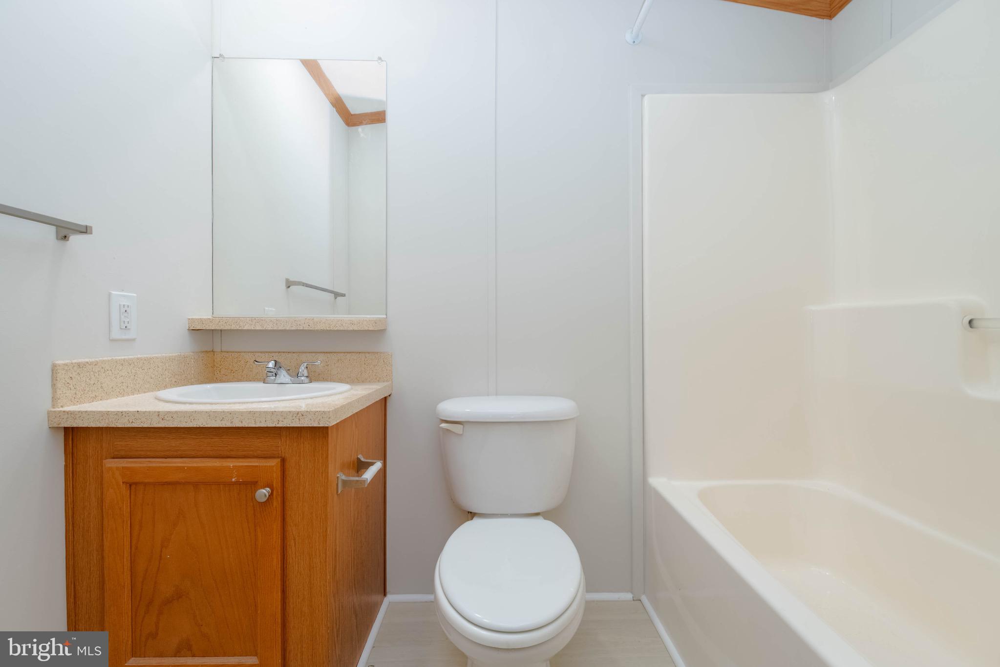 11540 Philadelphia Road White Marsh, MD 21162 - Photo 21 of 32 a bathroom with a sink a toilet and a bathtub
