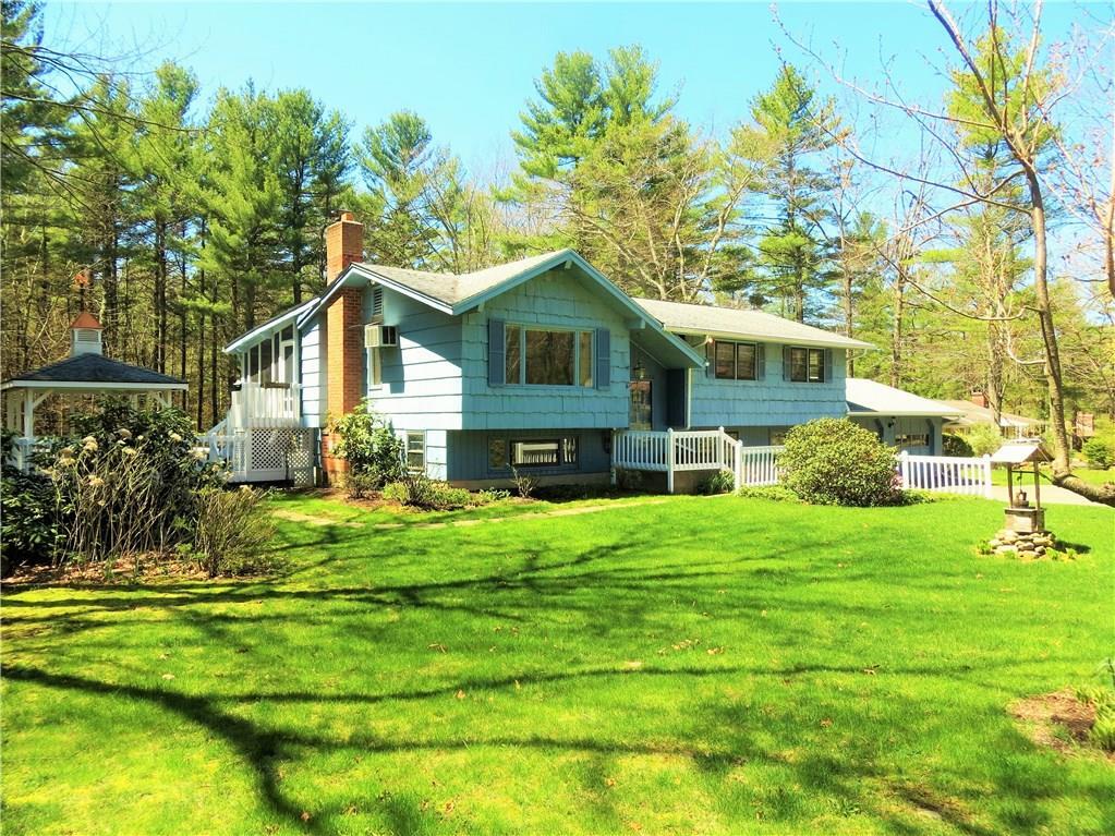 95 Browns Bridge Road Tolland, CT 06084 - Photo 1 of 1 a house that is sitting in front of a big yard with potted plants and large trees
