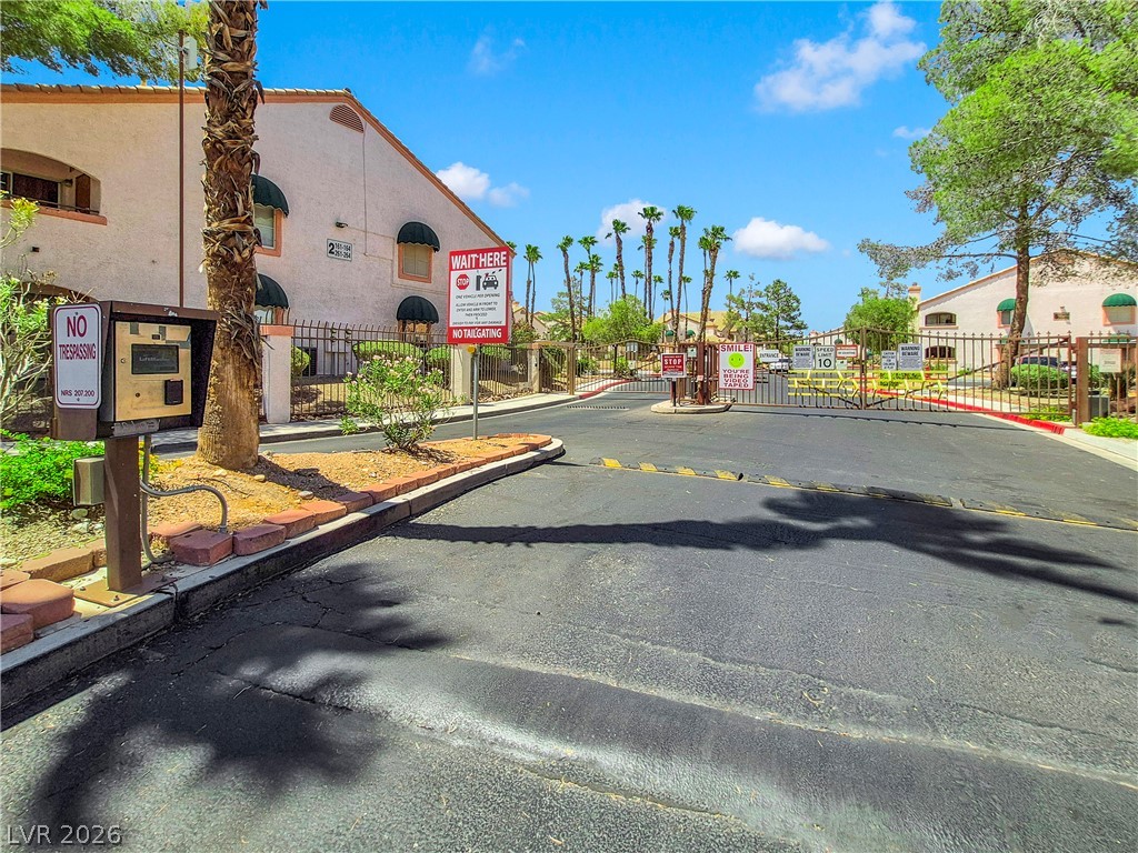 7570 West Flamingo Road, Unit 115 Las Vegas, NV 89147 - Photo 31 of 34 Secure community entrance with an inviting drive.