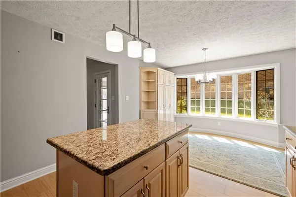 a bathroom with a granite countertop sink and a large mirror