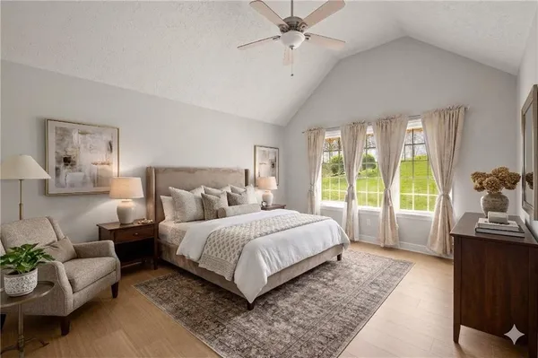 a large bedroom with a bed and large window