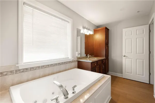 a bathroom with a tub and a sink