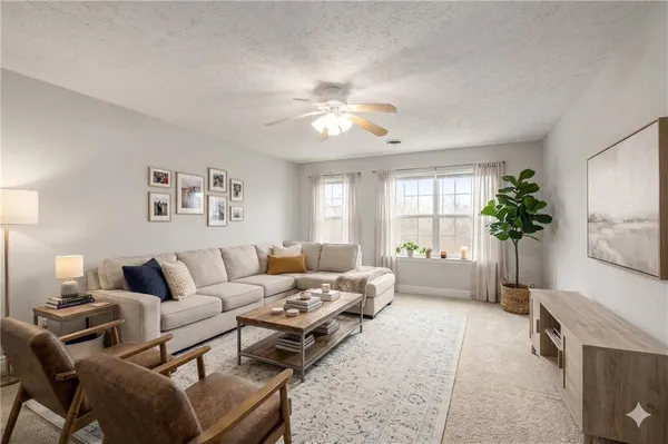 a living room with furniture and a potted plant