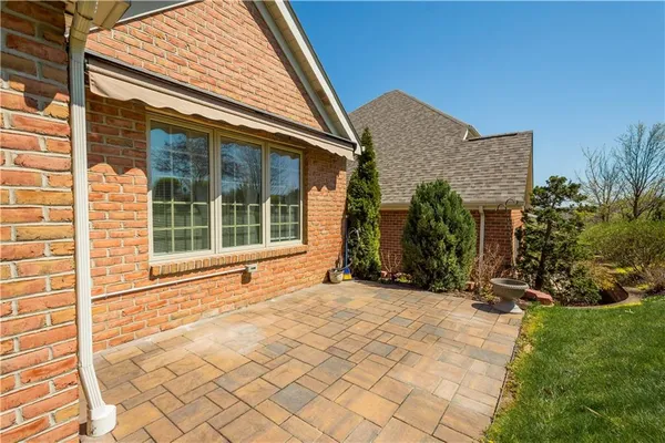 a view of house with backyard and glass windows