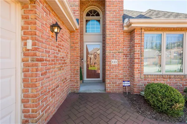 a view of a brick house with many windows