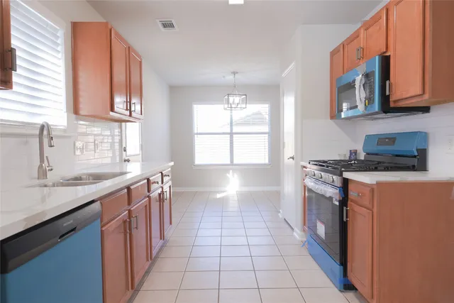 a kitchen with stainless steel appliances granite countertop a stove and a sink