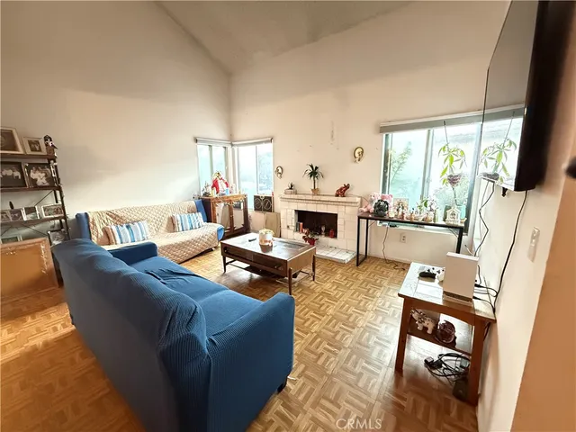 a living room with furniture large window and a table