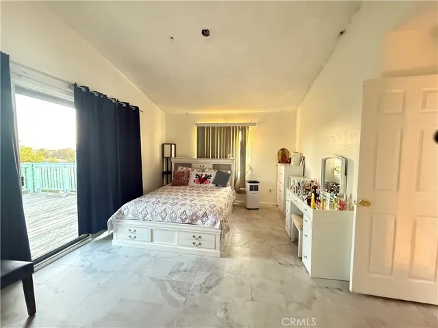 a living room with a bed furniture and a window