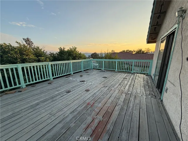 a view of deck with wooden floor and fence and a floor to ceiling window