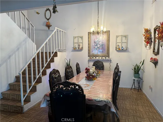 a view of a livingroom with furniture and staircase