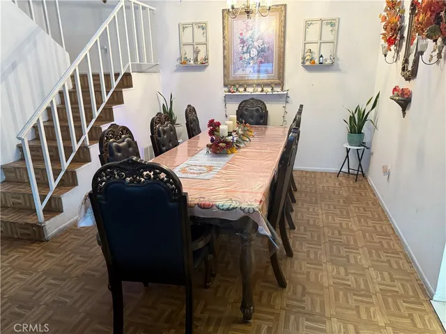 a view of a dining room with furniture and a chandelier