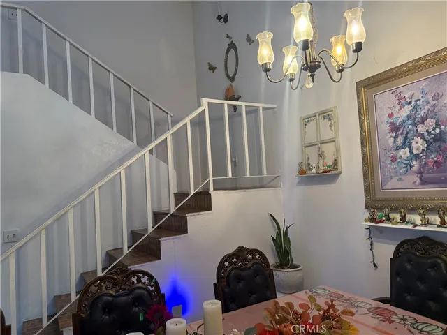 a view of a dining room with furniture and a chandelier
