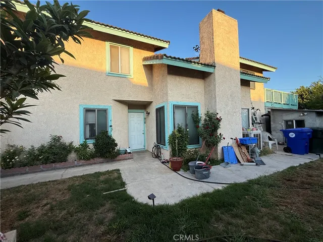 a view of a house with backyard and sitting area