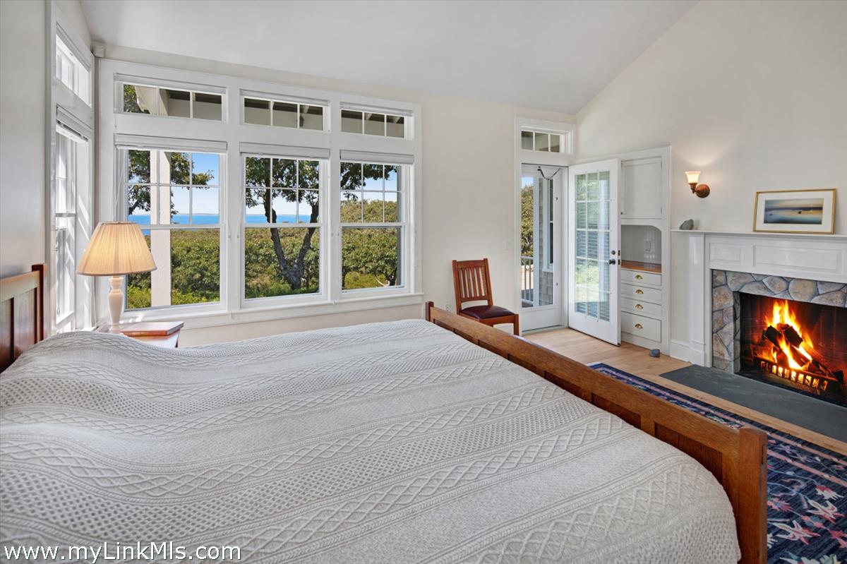 78 Hammett Road Chilmark, MA 02535 - Photo 22 of 53 a bedroom with furniture and a fireplace
