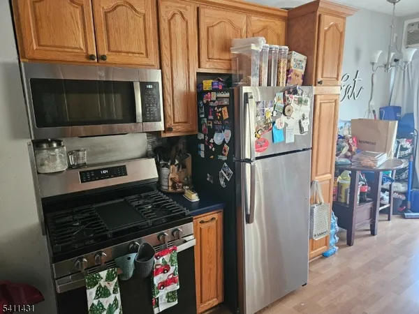 a kitchen with stainless steel appliances granite countertop a stove and a refrigerator