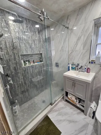 a bathroom with a sink a mirror and a shower