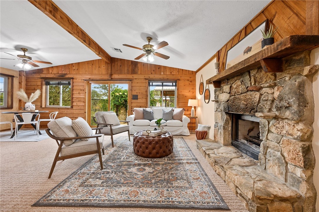 101 Oneil Ranch Road Dripping Springs, TX 78620 - Photo 1 of 1 a living room with furniture a fireplace and a floor to ceiling window