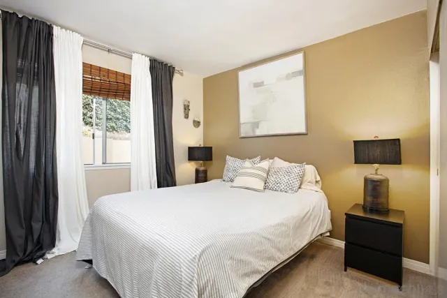 a bedroom with a bed and a television