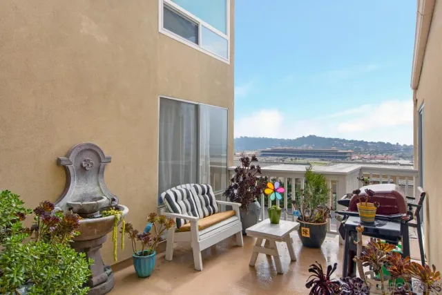 a view of a patio with a table chairs and a floor to ceiling window