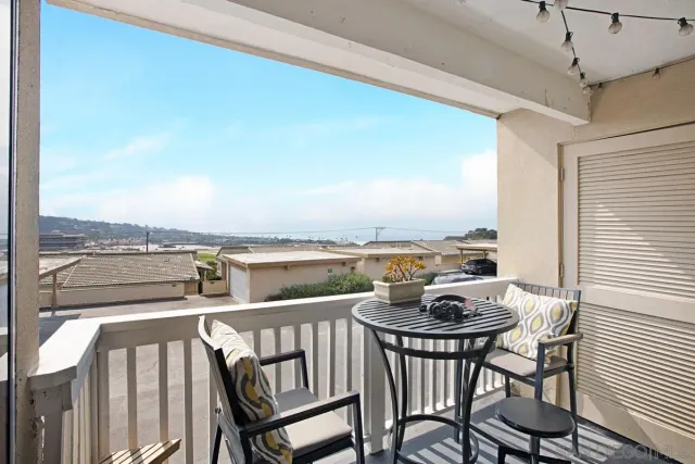 a view of a balcony with furniture