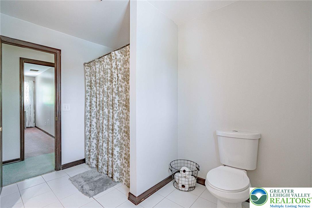 3857 Friedens Road Slatington, PA 18080 - Photo 46 of 75 This bathroom features white tiled flooring and a convenient shower area.
