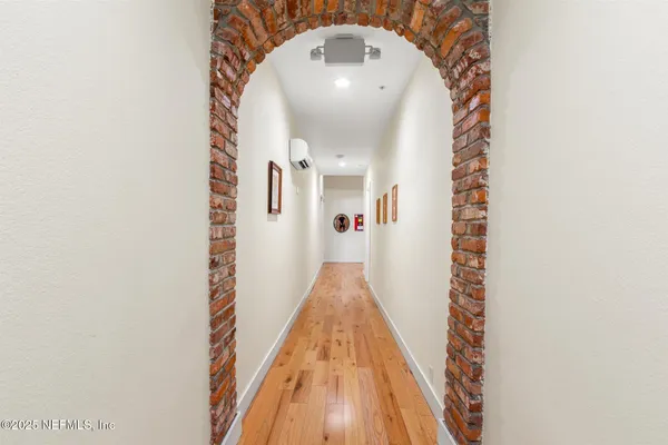 a view of a hallway with wooden floor