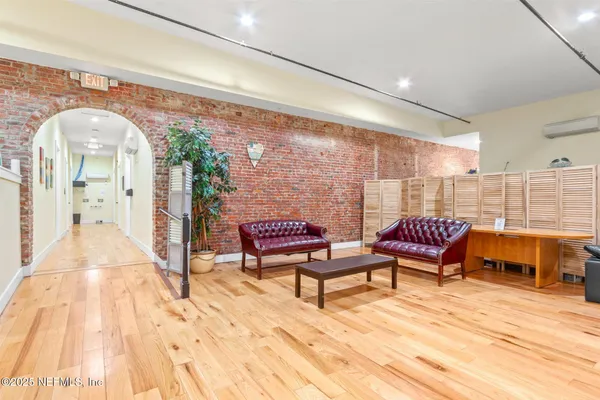 a view of a balcony with chairs and wooden floor