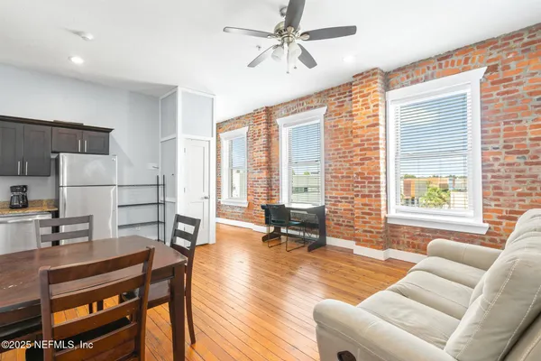 a living room with furniture a large window and a table
