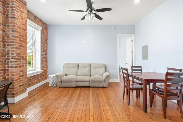 a living room with furniture and a wooden floor