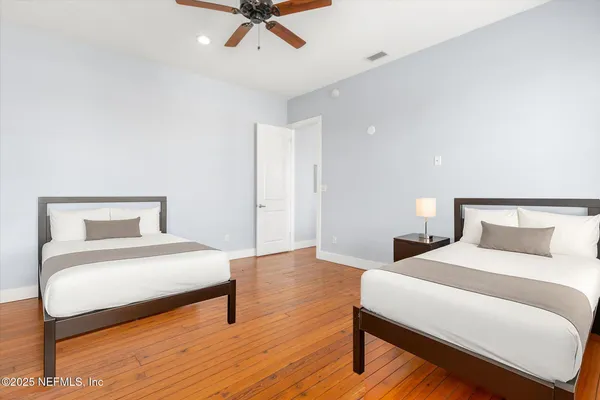 a bedroom with a bed and a night stand