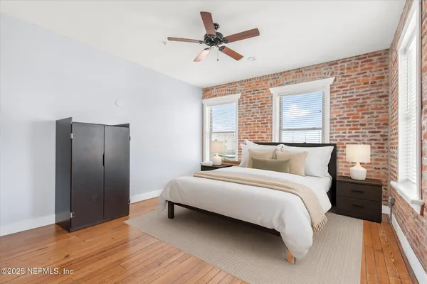 a bedroom with a bed and a ceiling fan