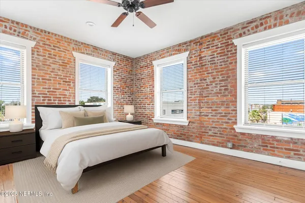 a bedroom with a large bed and a window