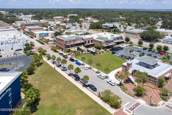 an aerial view of residential houses with outdoor space