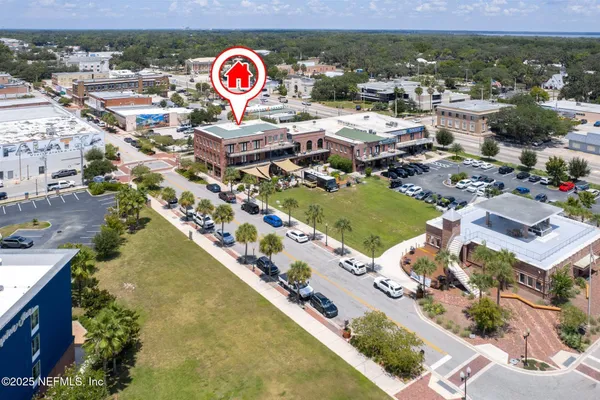 an aerial view of residential houses with outdoor space