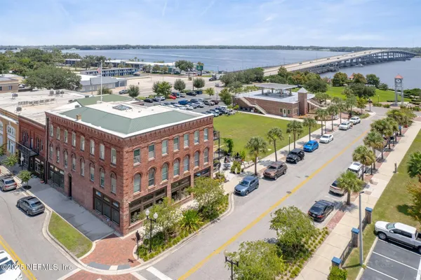 a sign board with buildings in the background
