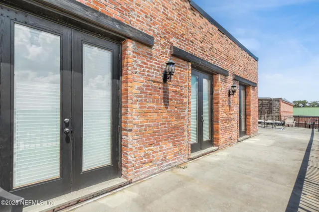 a living room with furniture a large window and a table