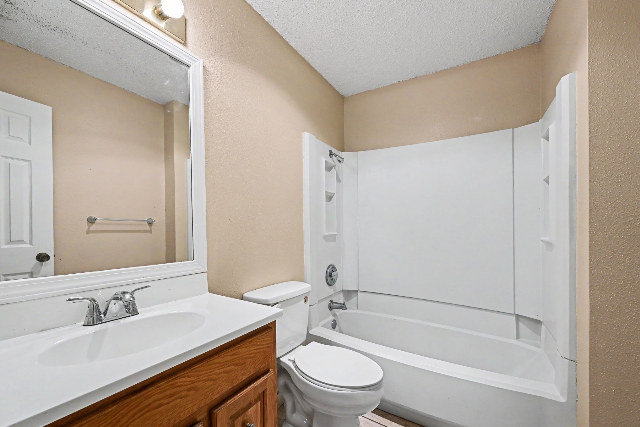8406 Forest Ridge Drive San Antonio, TX 78239 - Photo 15 of 33 a bathroom with a granite countertop bathtub shower sink mirror vanity and toilet